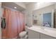 Bathroom featuring a vanity with sink and a peach colored shower curtain at 523 S 201St Ave, Buckeye, AZ 85326