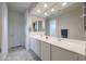 Bright bathroom featuring a double sink vanity, large mirror, and tiled floor at 523 S 201St Ave, Buckeye, AZ 85326