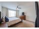 Cozy bedroom with a ceiling fan, natural light, and a wooden dresser at 523 S 201St Ave, Buckeye, AZ 85326