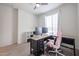 Cozy bedroom featuring a ceiling fan, large window, and workstation at 523 S 201St Ave, Buckeye, AZ 85326