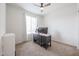 Simple bedroom setup with a workstation, carpet, and bright natural light at 523 S 201St Ave, Buckeye, AZ 85326