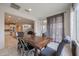 Open dining area that connects to the kitchen and living room, with a large wood table at 523 S 201St Ave, Buckeye, AZ 85326