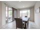 Dining room with a rustic table, comfortable chairs, and sliding glass doors to the backyard at 523 S 201St Ave, Buckeye, AZ 85326