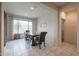 Bright dining room with a rustic table, stylish chairs, and a large window at 523 S 201St Ave, Buckeye, AZ 85326