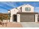 Charming two-story home featuring a stucco exterior, a brown garage door and drought-resistant landscaping at 523 S 201St Ave, Buckeye, AZ 85326