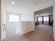 Hallway with carpeted floors, leading to bedroom with a neutral color palette and plenty of natural light at 523 S 201St Ave, Buckeye, AZ 85326