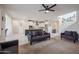 Stylish living room with open floor plan featuring cozy seating, open stairway and adjacent kitchen at 523 S 201St Ave, Buckeye, AZ 85326