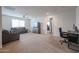 Relaxing living room features neutral walls, carpet flooring, modern furnishings, and plenty of natural light at 523 S 201St Ave, Buckeye, AZ 85326