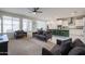 Open-concept living area featuring a central sofa, a kitchen island and an abundance of natural light at 523 S 201St Ave, Buckeye, AZ 85326