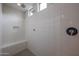 Modern walk-in shower with white tile, bench, and dual shower heads at 523 S 201St Ave, Buckeye, AZ 85326