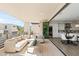 A stylish balcony showcases a cozy sofa and seamlessly connects to an open-plan dining area and modern kitchen inside at 5541 E Stella Ln, Paradise Valley, AZ 85253