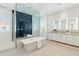 Serene bathroom with a freestanding tub, walk-in shower, dual sinks, and modern tile floors at 5541 E Stella Ln, Paradise Valley, AZ 85253