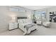 Bright bedroom featuring neutral tones, plush bedding, and shuttered windows at 5541 E Stella Ln, Paradise Valley, AZ 85253