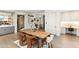 This dining area features a large wooden table, stylish chairs, and views into other rooms of the house at 5541 E Stella Ln, Paradise Valley, AZ 85253