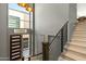 Staircase and foyer featuring hardwood floors, a metal railing, and an accent light at 5541 E Stella Ln, Paradise Valley, AZ 85253