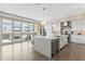 Open floor plan kitchen with a large center island, stainless steel appliances, and an adjacent outdoor patio at 5541 E Stella Ln, Paradise Valley, AZ 85253