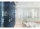 Modern shower design with a glass enclosure, sleek black tiles, and multiple showerheads at 5541 E Stella Ln, Paradise Valley, AZ 85253