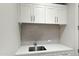 Modern wet bar featuring shaker cabinets, quartz countertops, and a stainless steel sink at 5541 E Stella Ln, Paradise Valley, AZ 85253