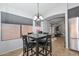 Cozy dining area with a dark wood table, chandelier, and natural light from nearby windows at 5726 W Mercury Way, Chandler, AZ 85226