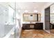 Bright bathroom featuring a glass shower, double vanity, and travertine tile floor at 6105 W Kimberly Way, Glendale, AZ 85308