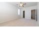 Bright bedroom with neutral carpet, ceiling fan, window, and closet at 6105 W Kimberly Way, Glendale, AZ 85308