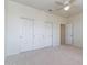 Neutral bedroom features closet with sliding doors, ceiling fan, and carpet at 6105 W Kimberly Way, Glendale, AZ 85308