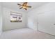 Bright bedroom featuring neutral paint and carpet, a ceiling fan, and closet at 6105 W Kimberly Way, Glendale, AZ 85308