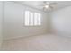 Bright bedroom with neutral carpet, a window with shutter blinds, and electrical outlets at 6105 W Kimberly Way, Glendale, AZ 85308