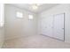 Bright bedroom with neutral carpet, ceiling fan, windows with blinds, and a closet at 6105 W Kimberly Way, Glendale, AZ 85308