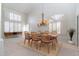 Bright dining room featuring a chandelier, neutral colors, and plantation shutters at 6105 W Kimberly Way, Glendale, AZ 85308