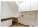 Bright laundry room with cabinets, countertops, and a utility sink at 6105 W Kimberly Way, Glendale, AZ 85308