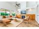 Bright and airy living room with vaulted ceilings, a fireplace, and built-in cabinets at 6105 W Kimberly Way, Glendale, AZ 85308