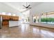 Open concept living room showcasing tile floors, ample natural light, and a modern kitchen at 6105 W Kimberly Way, Glendale, AZ 85308