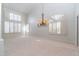 Bright living room featuring a chandelier, neutral colors, and plantation shutters at 6105 W Kimberly Way, Glendale, AZ 85308