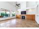 Spacious living room featuring a fireplace, built-in cabinets, and large windows with a view at 6105 W Kimberly Way, Glendale, AZ 85308