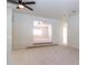 Open loft area with neutral carpet, fan, and staircase access to other rooms at 6105 W Kimberly Way, Glendale, AZ 85308