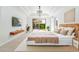 Relaxing main bedroom featuring a tray ceiling, stylish lighting, and a sliding glass door at 6105 W Kimberly Way, Glendale, AZ 85308