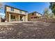 Wide angle of the yard showcasing a large gravel area, patio, and privacy fence at 6713 E Elmwood St, Mesa, AZ 85205