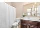 Well-maintained bathroom includes a shower with curtain and dark wood vanity at 6713 E Elmwood St, Mesa, AZ 85205