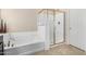 Bright bathroom featuring a separate tub and glass enclosed shower at 6713 E Elmwood St, Mesa, AZ 85205