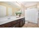 Bathroom featuring a long countertop and a view of the shower at 6713 E Elmwood St, Mesa, AZ 85205