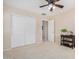 Bedroom featuring a closet and a view to an attached space at 6713 E Elmwood St, Mesa, AZ 85205