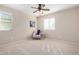 Well lit bedroom featuring two windows and neutral wall color at 6713 E Elmwood St, Mesa, AZ 85205