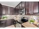 Close up of updated kitchen featuring granite countertops and stainless steel oven and range at 6713 E Elmwood St, Mesa, AZ 85205