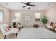 Bright living room featuring neutral walls, elegant furnishings, and a ceiling fan at 6713 E Elmwood St, Mesa, AZ 85205