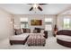 Bright living room boasts neutral walls, plush seating, and a modern ceiling fan at 6713 E Elmwood St, Mesa, AZ 85205