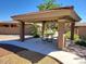 Picnic area featuring shaded pavilion, table with benches, sidewalk, and desert landscaping at 6713 E Elmwood St, Mesa, AZ 85205