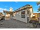 Low-maintenance gravel backyard with covered patio and gated access, perfect for outdoor enjoyment at 7038 N 28Th Ave, Phoenix, AZ 85051