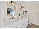 Bathroom with dual sinks, framed mirrors, and sleek fixtures at 7038 N 28Th Ave, Phoenix, AZ 85051