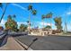 Gated community entrance with lush landscaping and towering palm trees, offering privacy at 7038 N 28Th Ave, Phoenix, AZ 85051